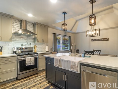 A kitchen with a stove top oven and a dishwasher.