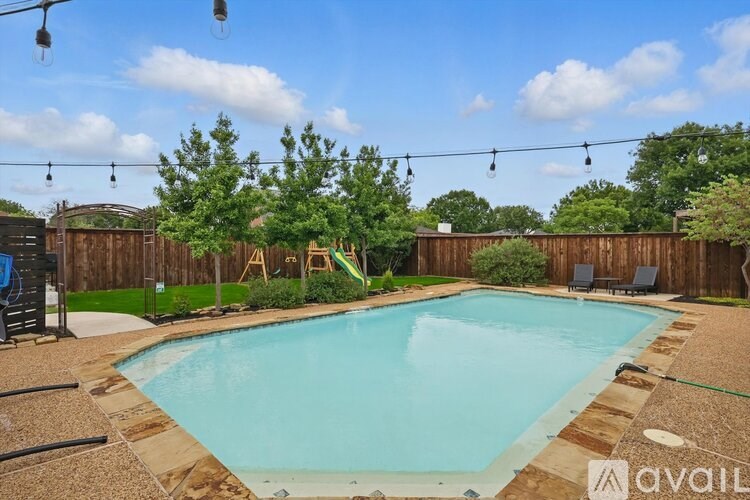 A backyard with a pool and a slide.