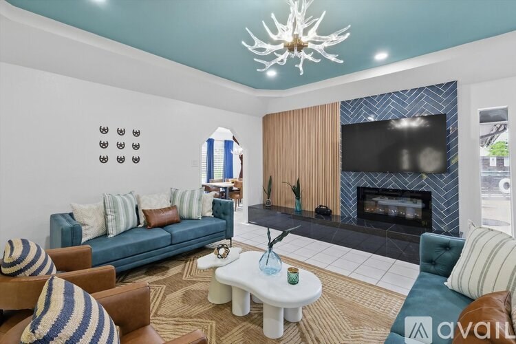 A living room with a fireplace and a television.