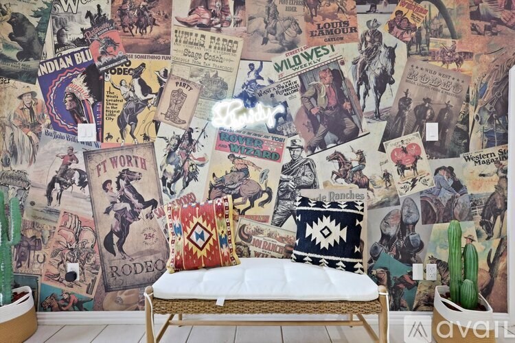 A room with a cowboy theme, featuring a bed with a white pillow and a cactus plant.