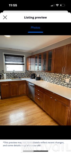 A kitchen with wooden cabinets and a granite countertop.