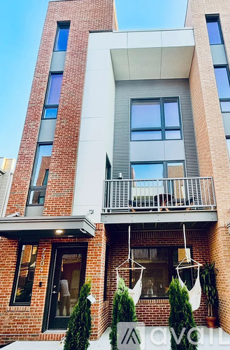 A modern building with a balcony and a glass door.