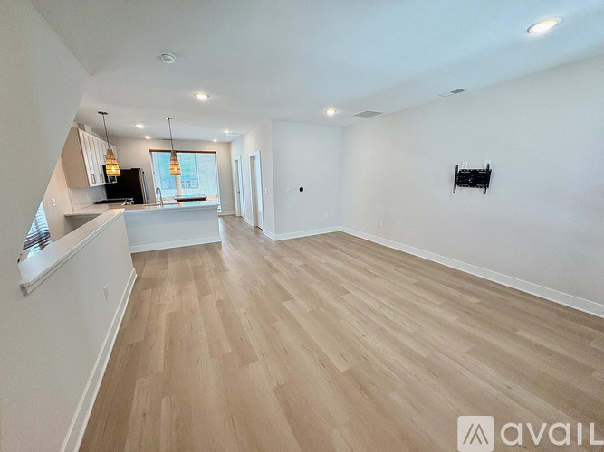 A modern kitchen with a dining table and chairs.