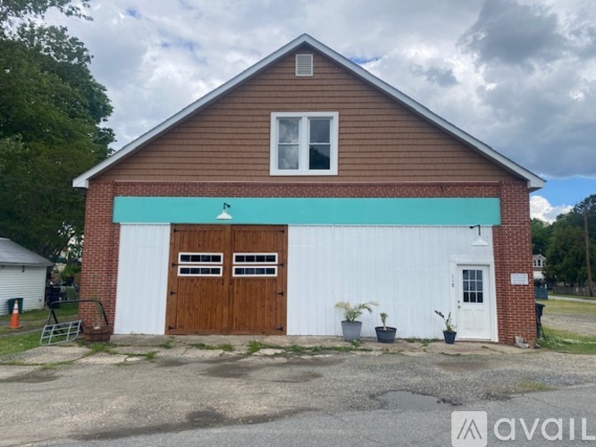 A two-story building with a white and brown garage door.