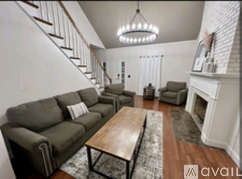 A living room with a grey couch and a wooden coffee table.