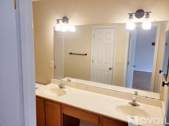 A bathroom with a sink and mirror.