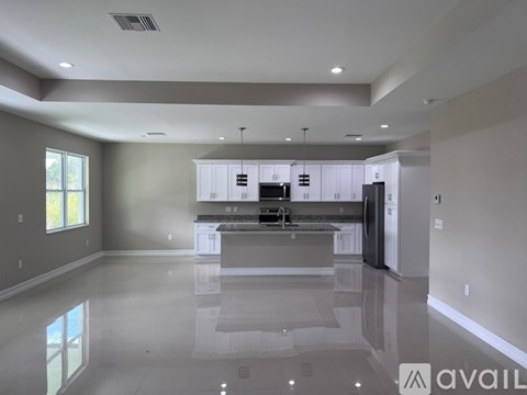 A spacious kitchen with a large island in the middle.