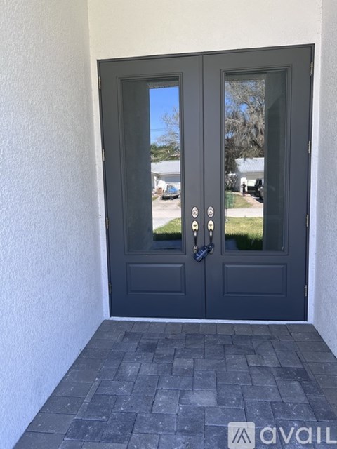 A grey door with a glass window and a handle.