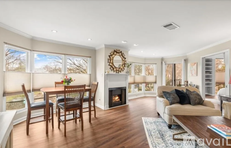A living room with a fireplace and a dining table.