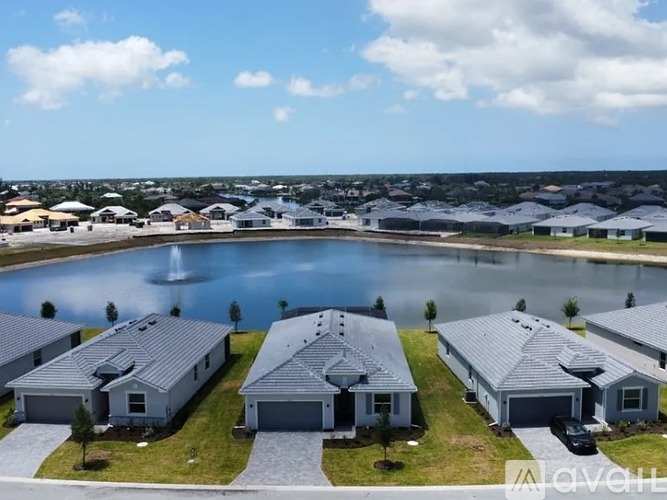 A row of houses with a pool in the foreground.