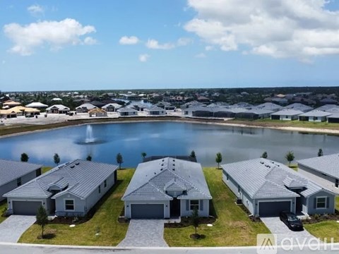 A row of houses with a pool in the foreground.