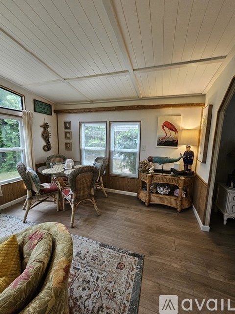 A living room with a table and chairs.
