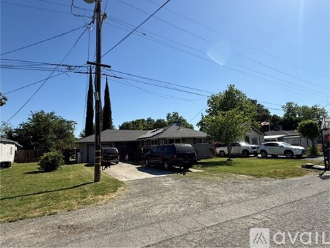 A residential area with houses and parked cars.