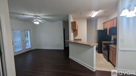 A room with a kitchenette and a dining area.