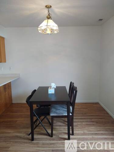 A dining room with a table and chairs.