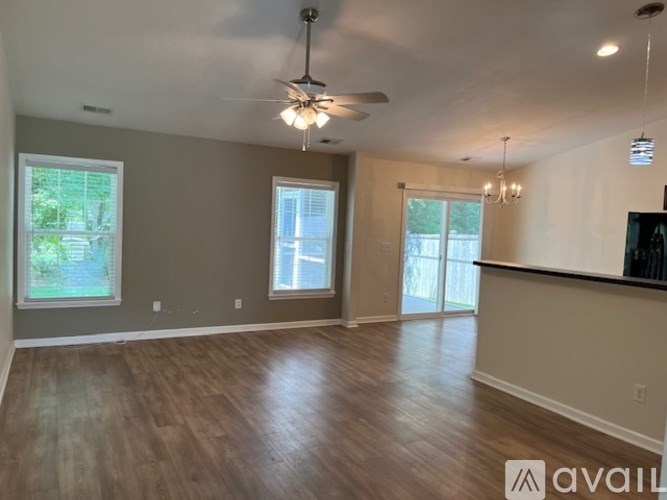 A bedroom with a bed, dresser, and window with blinds.