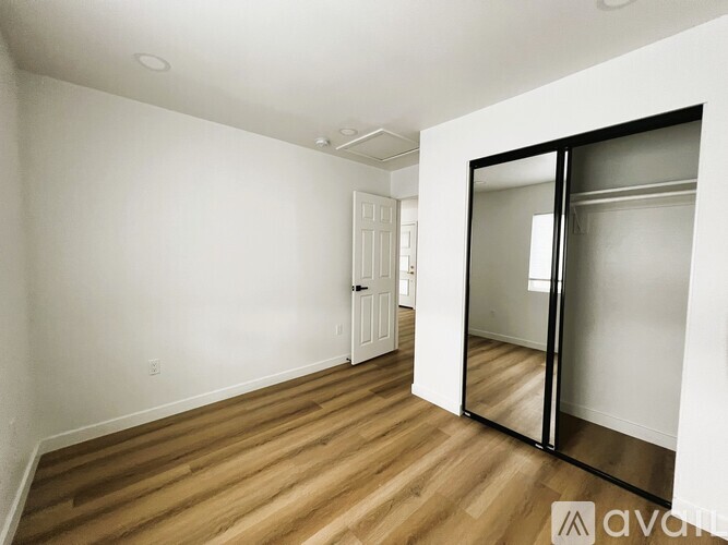 A room with wooden floors and a white door.