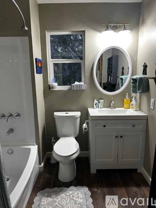 A bathroom with a toilet, sink, and bathtub.