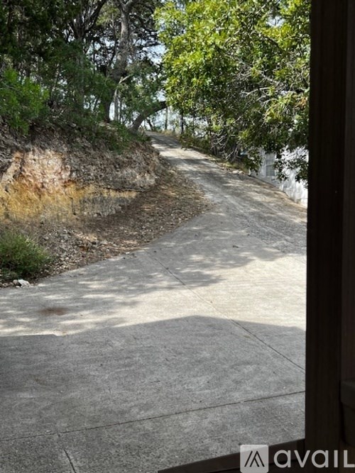 A sidewalk with a metal railing on the right side.