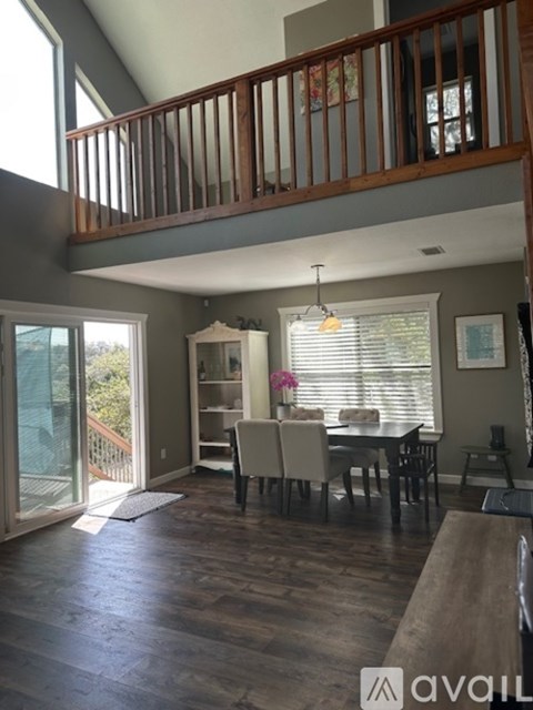 A living room with a dining table and chairs.