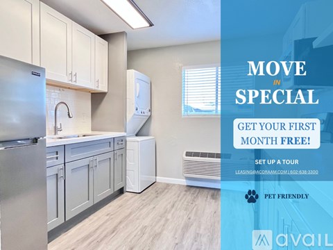 A kitchen with a refrigerator, cabinets, and a sink is on display for a move-in special.