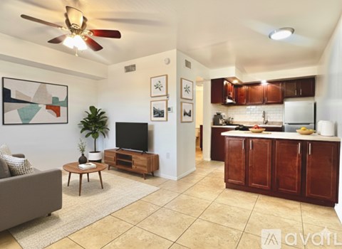 A pool area with a hot tub and lounge chairs.