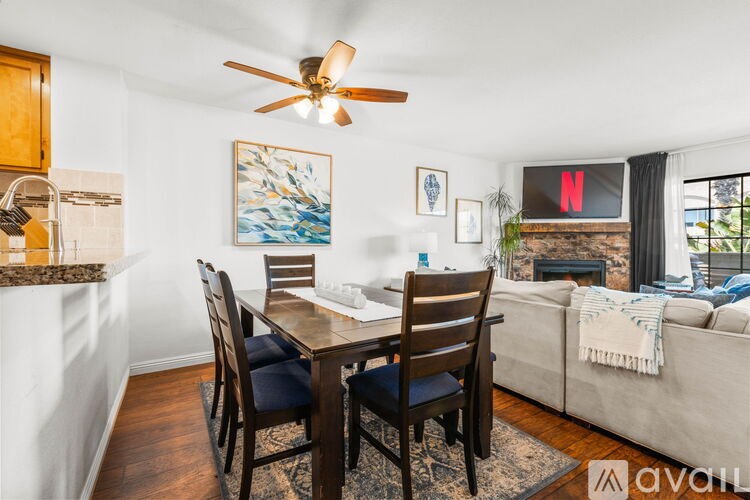 A living room with a dining table and chairs.