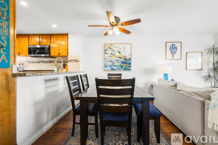 A dining room with a wooden table and chairs.