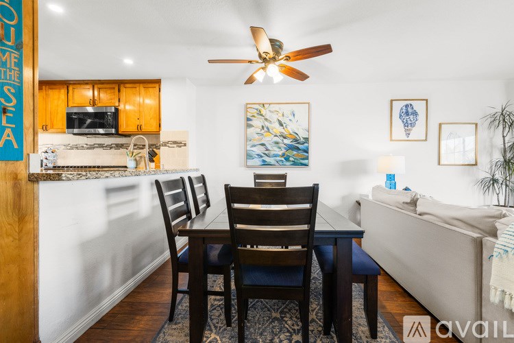 A dining room with a wooden table and chairs.