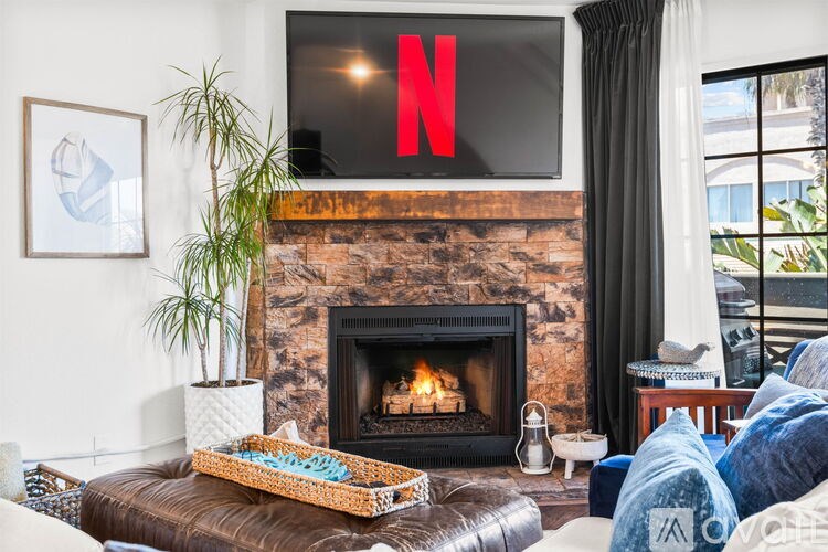 A living room with a fireplace and a Netflix logo on the TV.