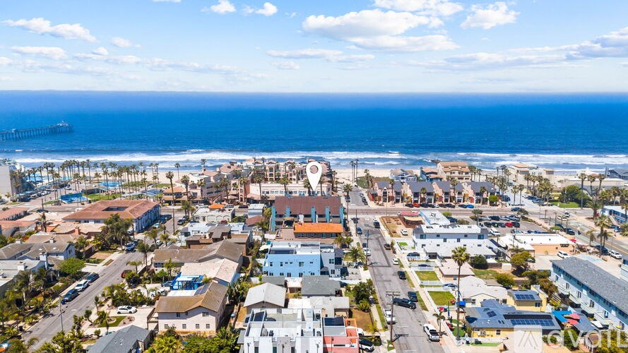 A coastal town with a pier and buildings.