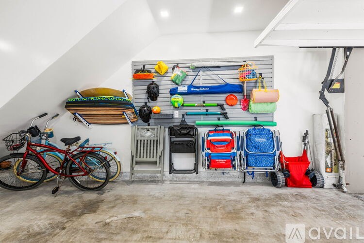 A red bicycle is parked in a garage.