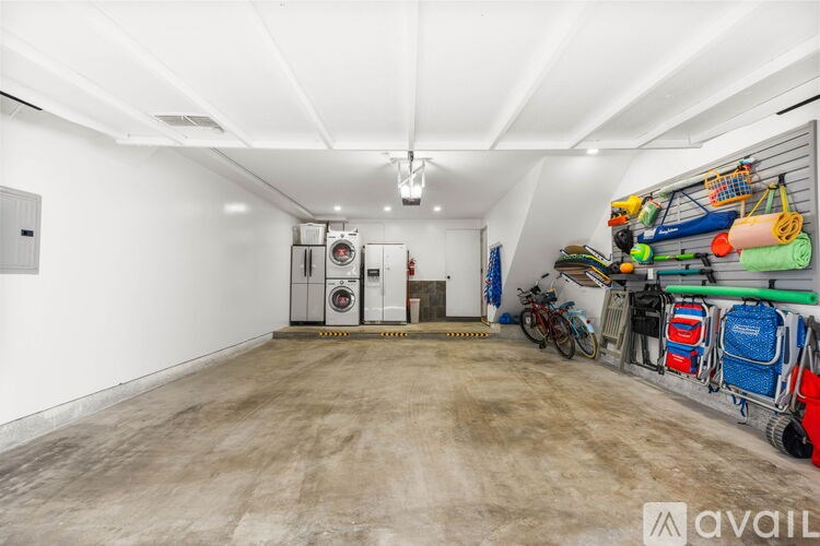 A storage room with a white ceiling and a variety of items stored on the shelves.