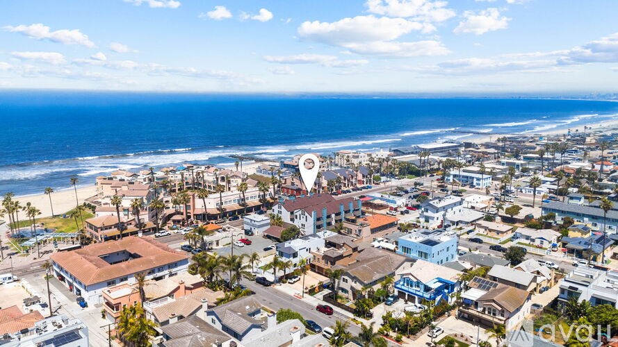 A bird's eye view of a coastal town with buildings and a beach.