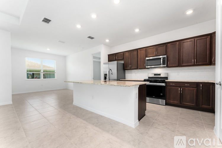A kitchen with brown cabinets and a white island.