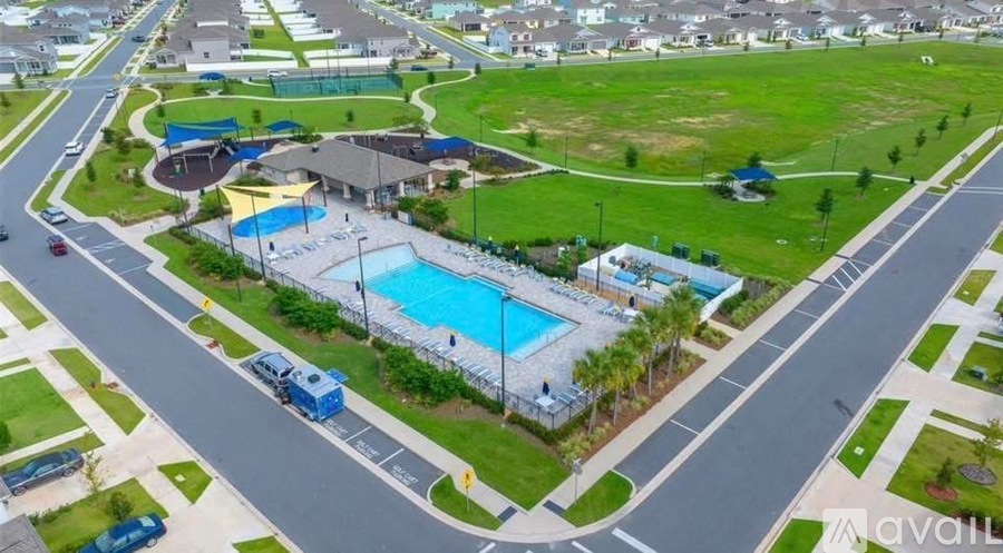 An aerial view of a community with a swimming pool and a playground.