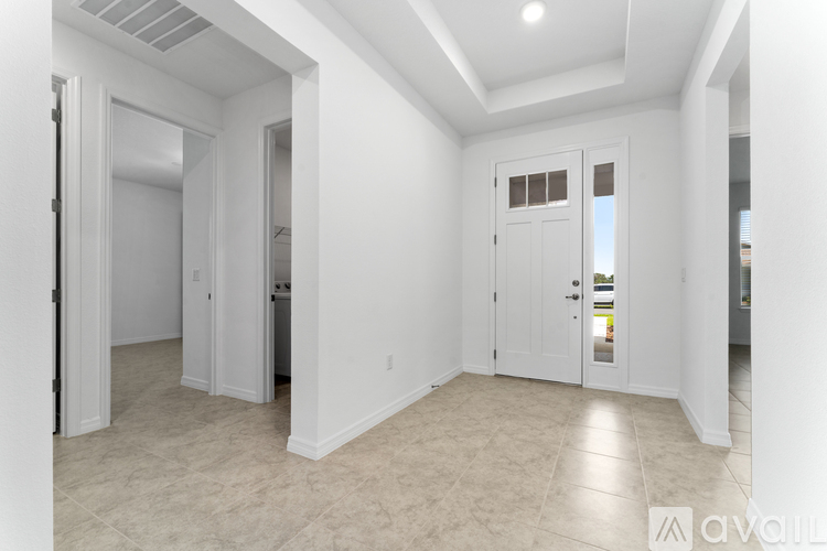 A spacious, empty room with white walls and a tiled floor.