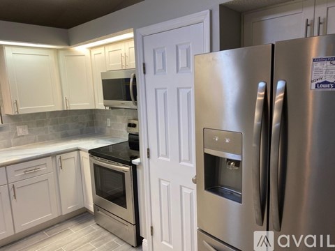 A kitchen with a stainless steel refrigerator and oven.
