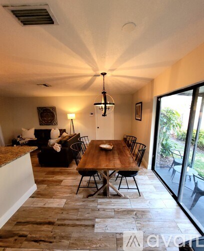 A dining room with a wooden table and chairs.