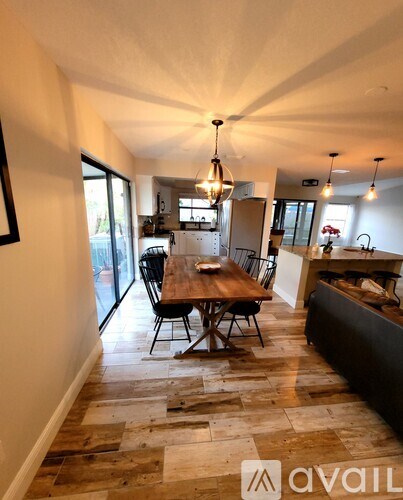 A kitchen with a table and chairs in the middle of the room.