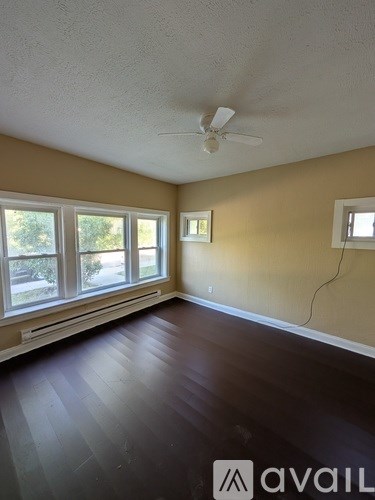 A room with a ceiling fan and a window.