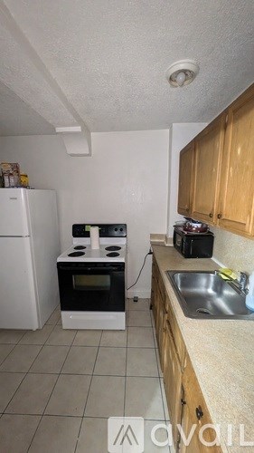 A room with a ceiling fan and a window.