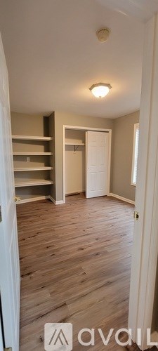 A room with wooden floors and a white door.