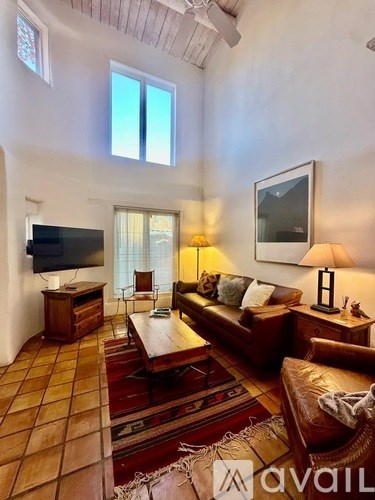 A living room with a brown couch and a flat screen TV.