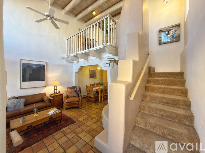 A living room with a staircase leading to the upper floor.