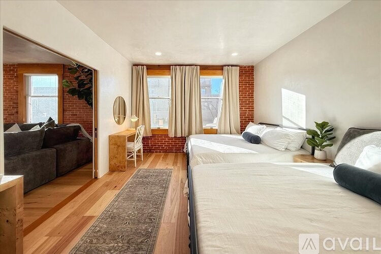 A bedroom with a large bed and a couch.