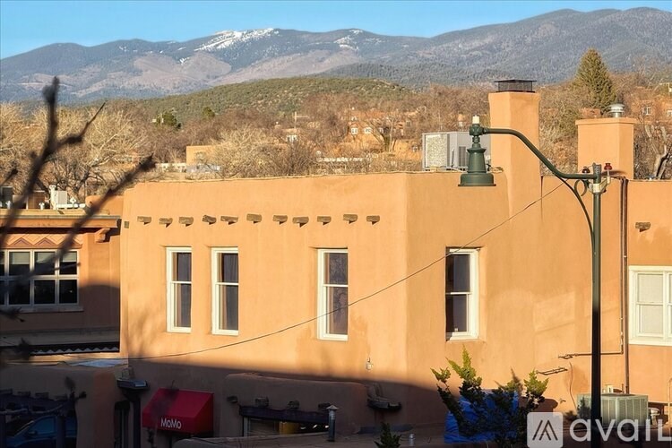 A building with a mountain range in the background.