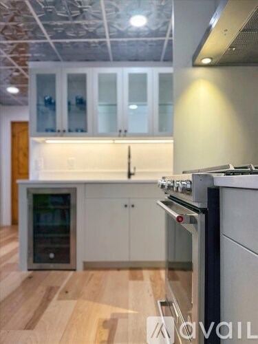 A kitchen with a stove top oven and a refrigerator.