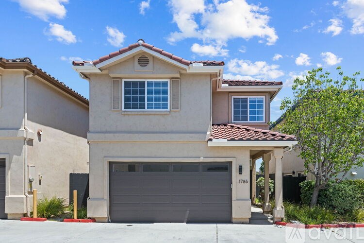 A house with a garage is for sale.