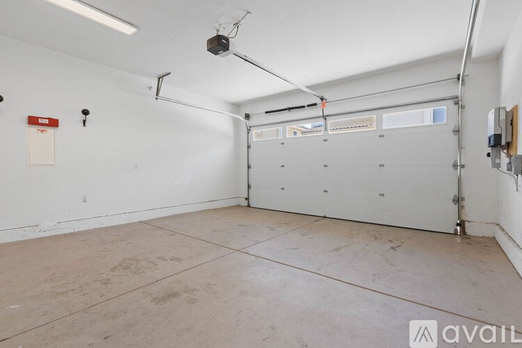 A large empty room with a concrete floor and white walls.